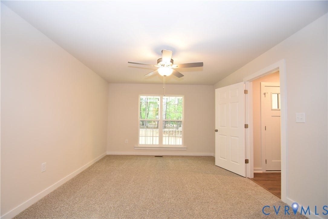 Lot 1 Bannister Town Road, Courtney Farms, Louisa, VA 23093 Interior room featuring neutral wall paint, carpeted flooring, a ceiling fan with integrated lighting, and a multi-pane window