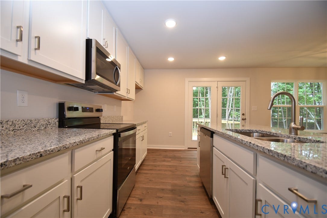 Lot 1 Bannister Town Road, Courtney Farms, Louisa, VA 23093 Kitchen featuring white shaker-style cabinetry, stone-finish countertops, stainless steel appliances, recessed lighting, and wood-finish flooring
