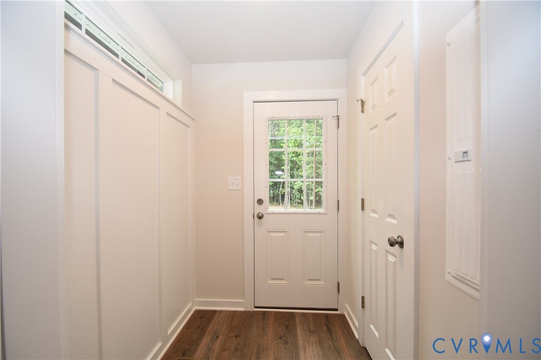 Lot 1 Bannister Town Road, Courtney Farms, Louisa, VA 23093 Entryway featuring wood-finish flooring, white board-and-batten wall detailing, a transom window, and an exterior door with glass pane inserts