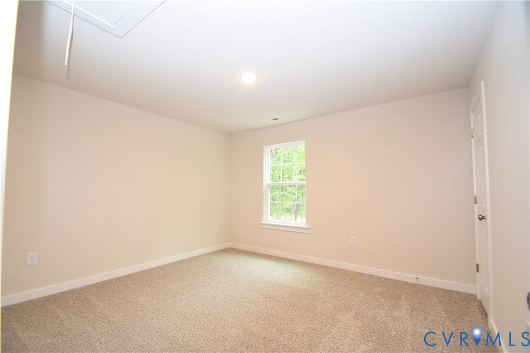 Lot 1 Bannister Town Road, Courtney Farms, Louisa, VA 23093 Neutral-toned interior space featuring wall-to-wall carpeting, a single-pane window with white trim, and a six-panel door