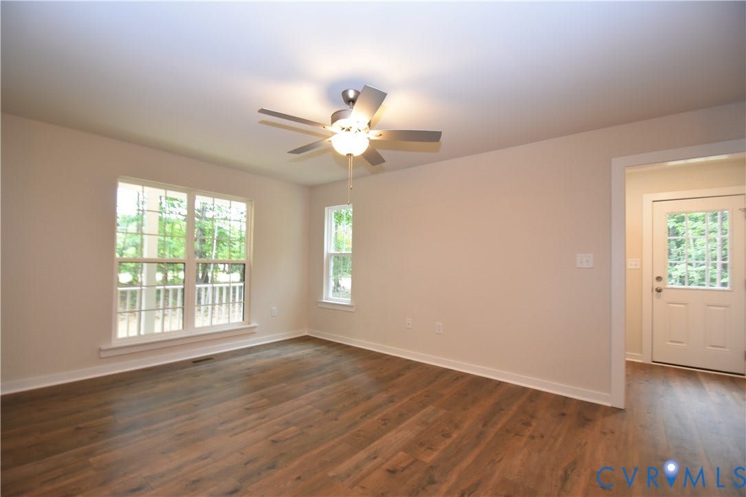 Lot 1 Bannister Town Road, Courtney Farms, Louisa, VA 23093 Interior space featuring wood-finish flooring, a multi-blade ceiling fan with integrated lighting, dual-pane windows, and a glass-paneled exterior door