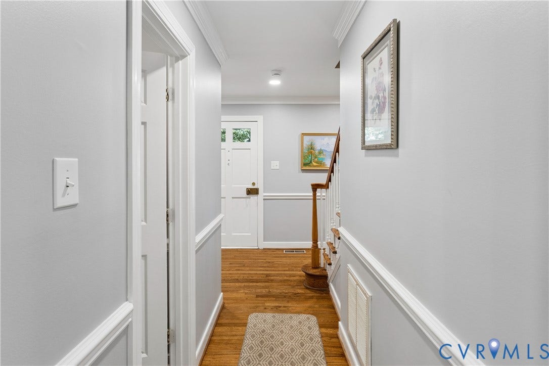 327 Huddersfield Drive, Chesterfield, VA 23236 Entryway featuring wood-finish flooring, white door with glass panels, chair rail molding, and a staircase with a wooden handrail