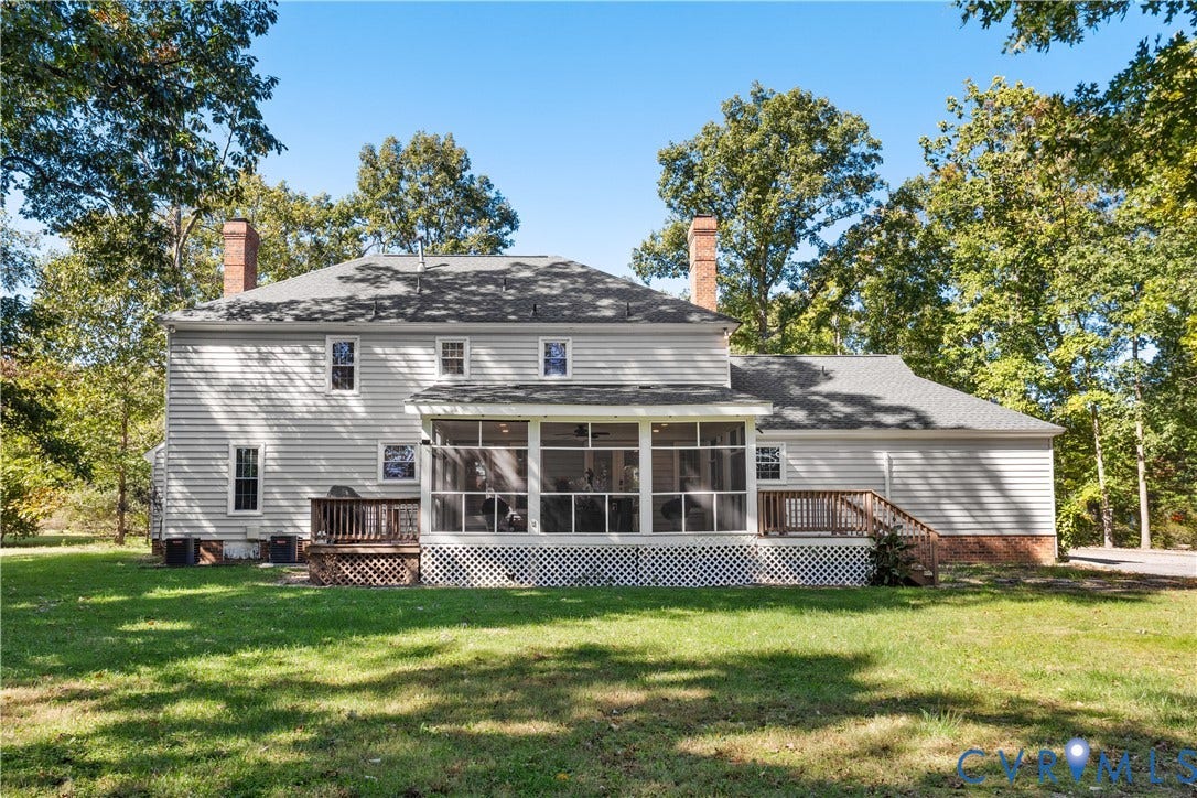 327 Huddersfield Drive, Chesterfield, VA 23236 Rear exterior featuring horizontal lap siding, two masonry chimneys, a large screened-in porch, an attached wooden deck, and a expansive lawn surrounded by mature trees