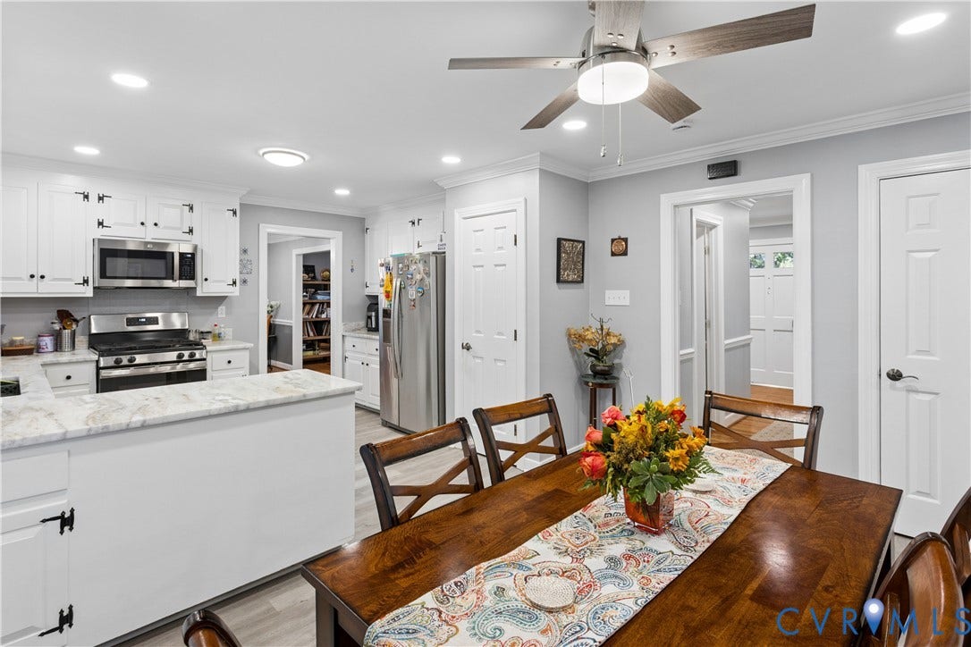327 Huddersfield Drive, Chesterfield, VA 23236 Kitchen featuring white shaker-style cabinetry, stone-surface countertops, stainless steel appliances, wood-finish flooring, and a ceiling-mounted light fixture with a fan