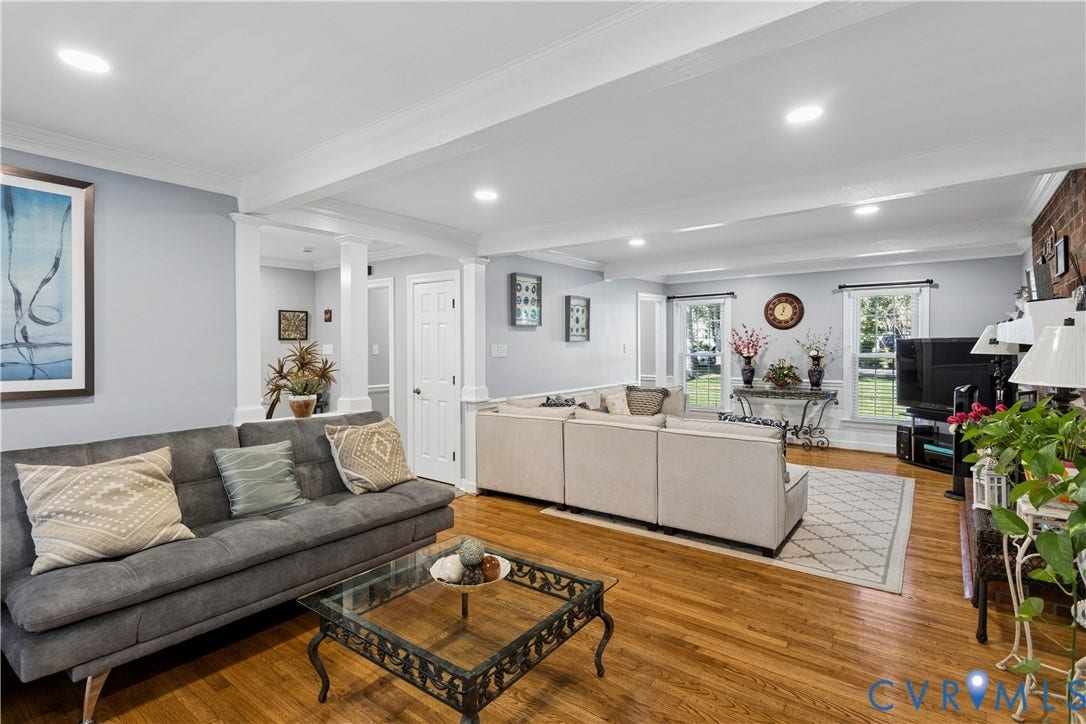 327 Huddersfield Drive, Chesterfield, VA 23236 Spacious living area featuring wood-finish flooring, recessed lighting, crown molding, decorative columns, and exposed brick masonry
