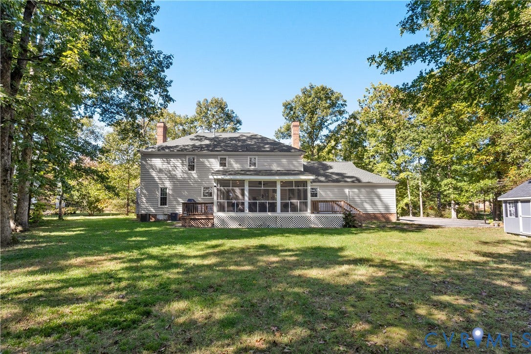 327 Huddersfield Drive, Chesterfield, VA 23236 Rear exterior featuring horizontal lap siding, a screened-in porch, dual brick chimneys, an open wood deck, and a expansive lawn surrounded by mature trees