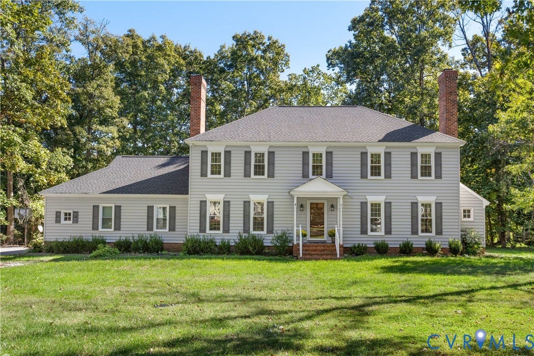 327 Huddersfield Drive, Chesterfield, VA 23236 Traditional exterior featuring horizontal siding, dual brick chimneys, symmetrical multi-pane windows with shutters, and an elevated entry portico