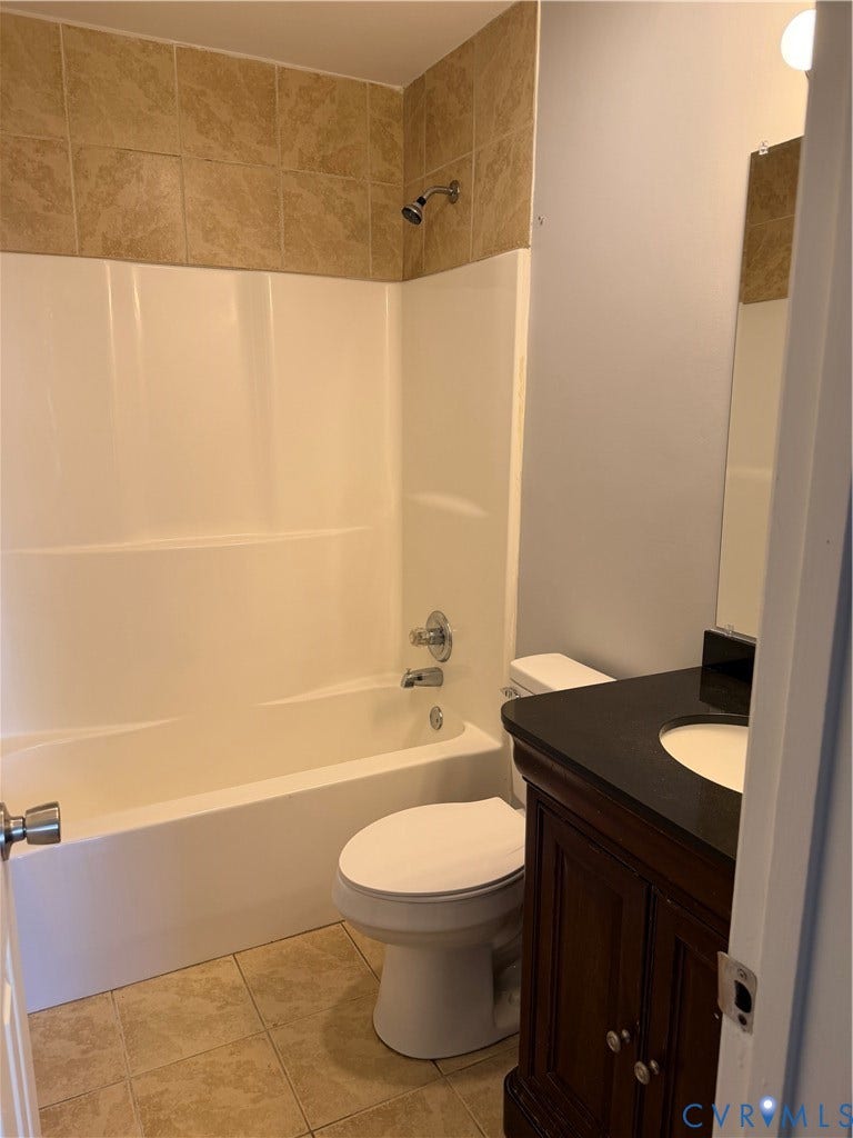 6149 Thierry Street, North Chesterfield, VA 23234 Bathroom featuring a vanity with a dark countertop and integrated sink, a combination shower and tub, and tile flooring