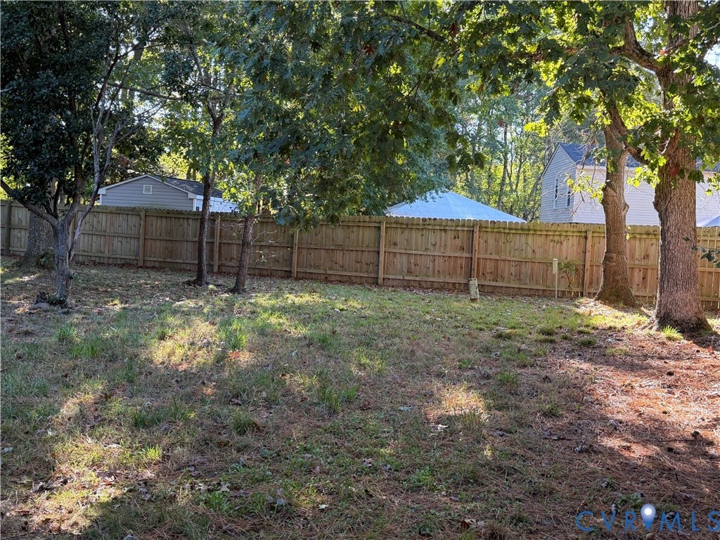 6149 Thierry Street, North Chesterfield, VA 23234 Expansive backyard featuring a wood privacy fence and mature canopy trees