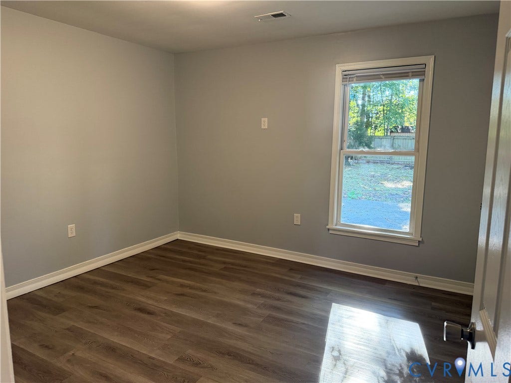 6149 Thierry Street, North Chesterfield, VA 23234 Interior space featuring wood-finish flooring, light-toned wall paint, and a single-hung window with casing