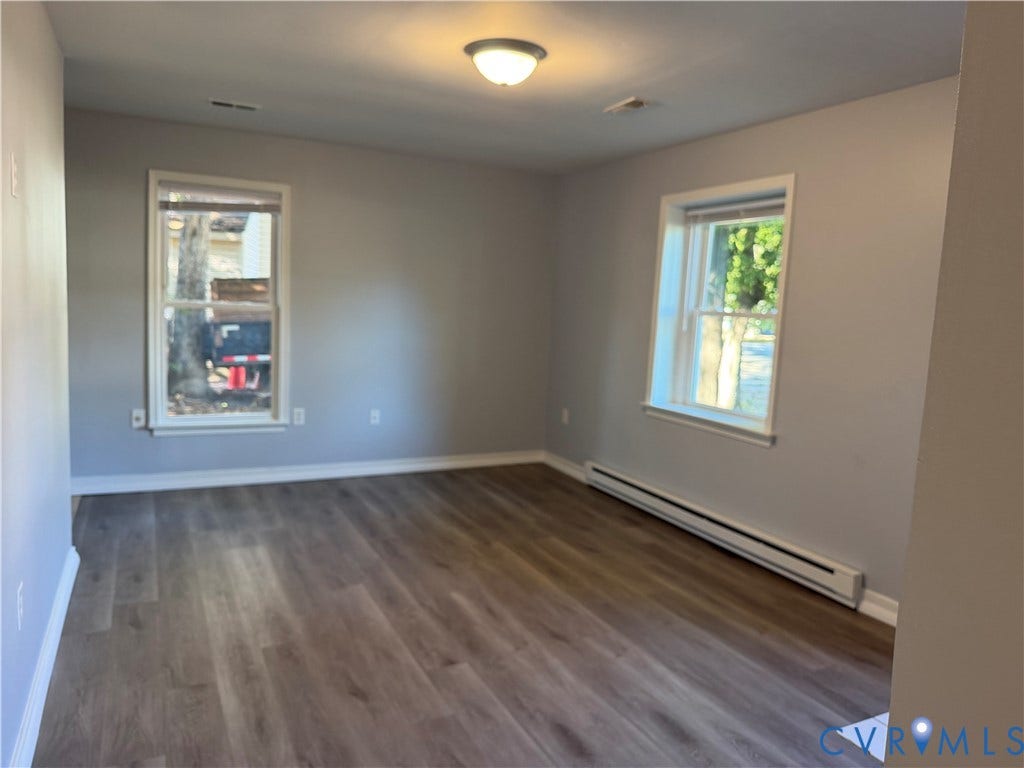 6149 Thierry Street, North Chesterfield, VA 23234 Neutral interior room featuring wood-finish flooring, dual windows, and a ceiling-mounted light fixture