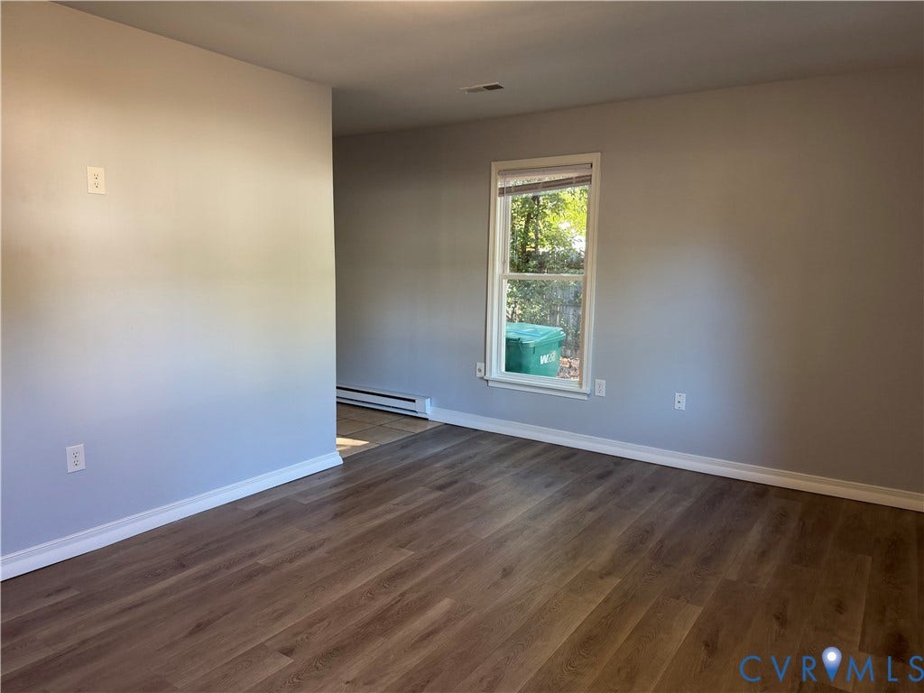 6149 Thierry Street, North Chesterfield, VA 23234 Room featuring wood-finish flooring, neutral wall paint, and a single-pane window