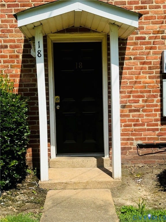 3517 Briel Street, #U18, Richmond, VA 23223 Exterior entry featuring a red brick facade, a covered portico with dual white support columns, and a solid black entry door