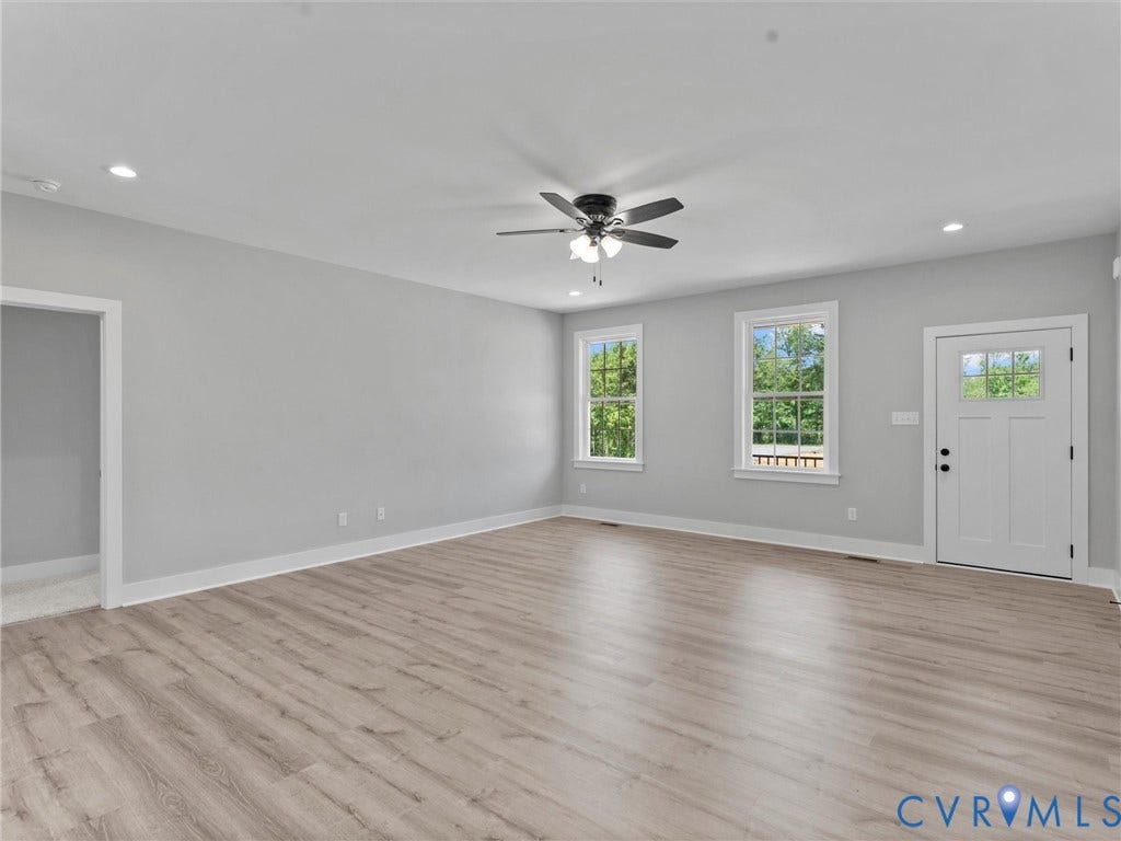 5951 Pot Rock Lane, Pot Rock Ln, Jetersville, VA 23083 Open-concept interior featuring wood-finish flooring, recessed lighting, a central ceiling fan with integrated light fixture, two double-pane windows, and an exterior door with a glass pane