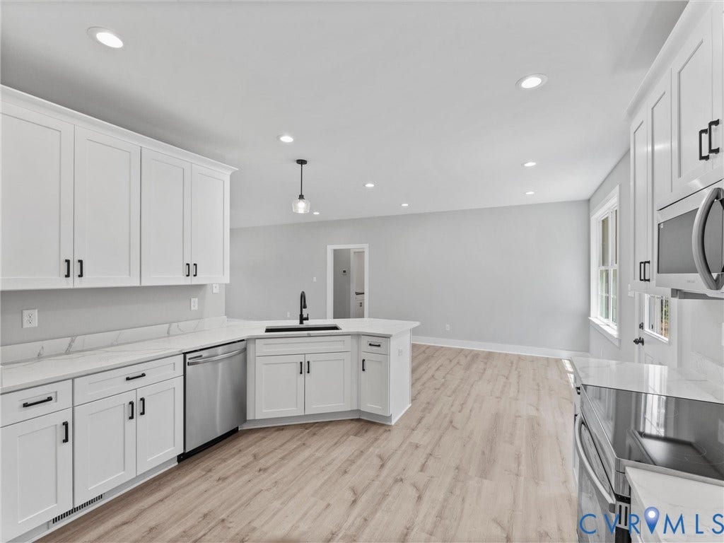 5951 Pot Rock Lane, Pot Rock Ln, Jetersville, VA 23083 Kitchen featuring white shaker-style cabinetry, solid-surface countertops, wood-finish flooring, stainless steel appliances, and recessed lighting
