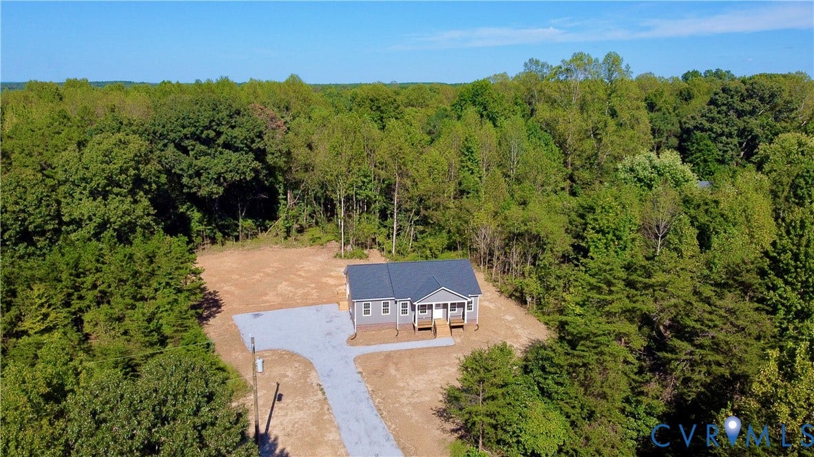 5951 Pot Rock Lane, Pot Rock Ln, Jetersville, VA 23083 Single-story residence featuring a gray exterior, covered front porch, asphalt shingle roof, and a gravel driveway on a wooded lot