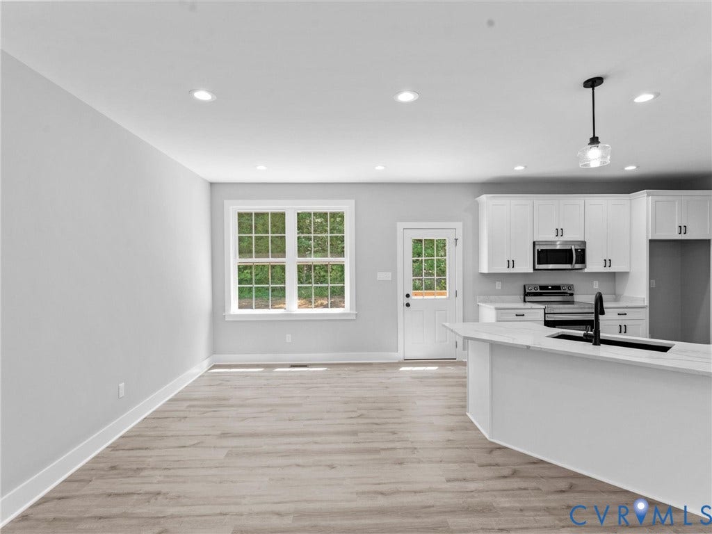 5951 Pot Rock Lane, Pot Rock Ln, Jetersville, VA 23083 Kitchen featuring white cabinetry, wood-finish flooring, recessed lighting, a kitchen island, and a glass-panel exterior door