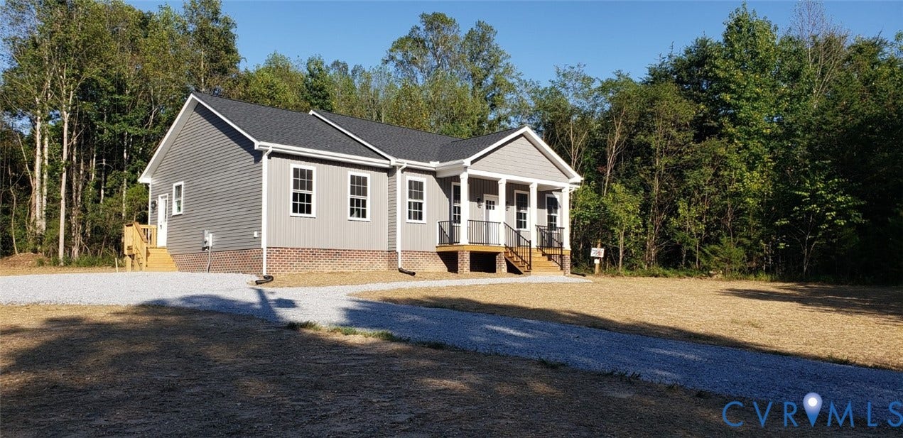 5951 Pot Rock Lane, Pot Rock Ln, Jetersville, VA 23083 Single-story residence featuring gray vinyl siding, a brick water table, dark shingled roof, a front porch with support columns, and a gravel driveway