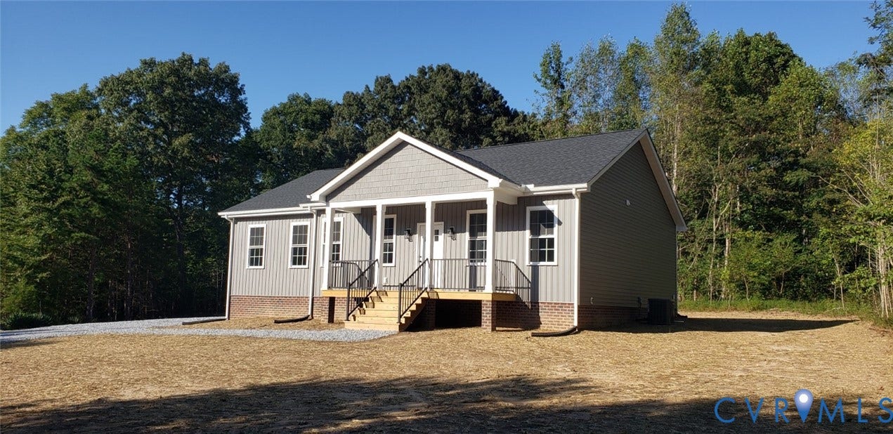 5951 Pot Rock Lane, Pot Rock Ln, Jetersville, VA 23083 Single-story residence featuring vinyl siding, a brick foundation, a gable roofline, and a covered front porch with a metal railing