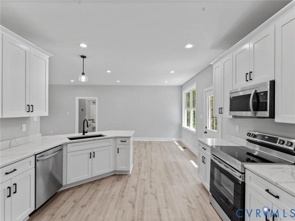 5951 Pot Rock Lane, Pot Rock Ln, Jetersville, VA 23083 Kitchen featuring white shaker-style cabinetry, stainless steel appliances, light-toned wood-finish flooring, recessed lighting, and stone-surface countertops