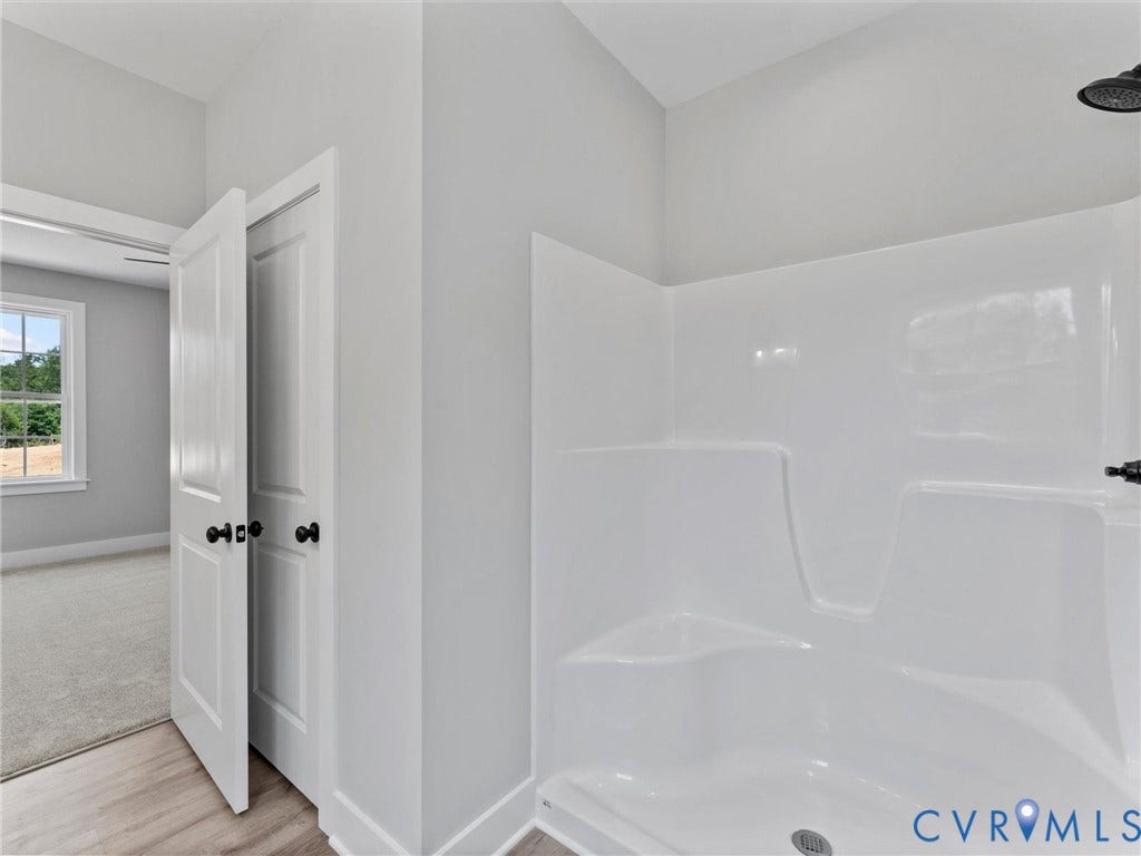 5951 Pot Rock Lane, Pot Rock Ln, Jetersville, VA 23083 Molded acrylic shower surround with integrated seating, matte black shower fixture, and interior doors featuring matte black hardware