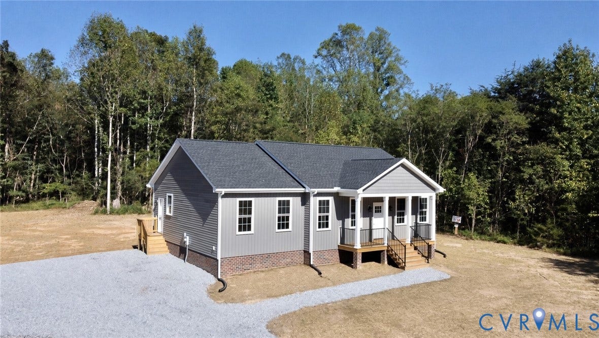5951 Pot Rock Lane, Pot Rock Ln, Jetersville, VA 23083 Single-story residence featuring horizontal and vertical siding, a brick foundation, a covered front porch, and a gravel driveway
