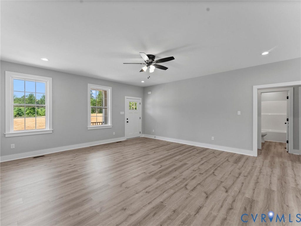 5951 Pot Rock Lane, Pot Rock Ln, Jetersville, VA 23083 Interior space featuring wood-finish flooring, recessed lighting, a multi-blade ceiling fan with integrated light fixture, dual windows, and a glass-paneled exterior door