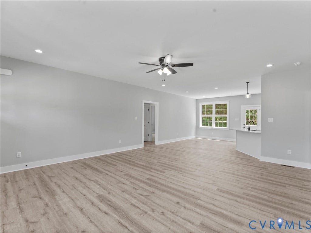 5951 Pot Rock Lane, Pot Rock Ln, Jetersville, VA 23083 Spacious room featuring wood-finish flooring, recessed lighting, a ceiling fan with integrated lighting, a multi-pane window, and a breakfast bar with pendant lighting