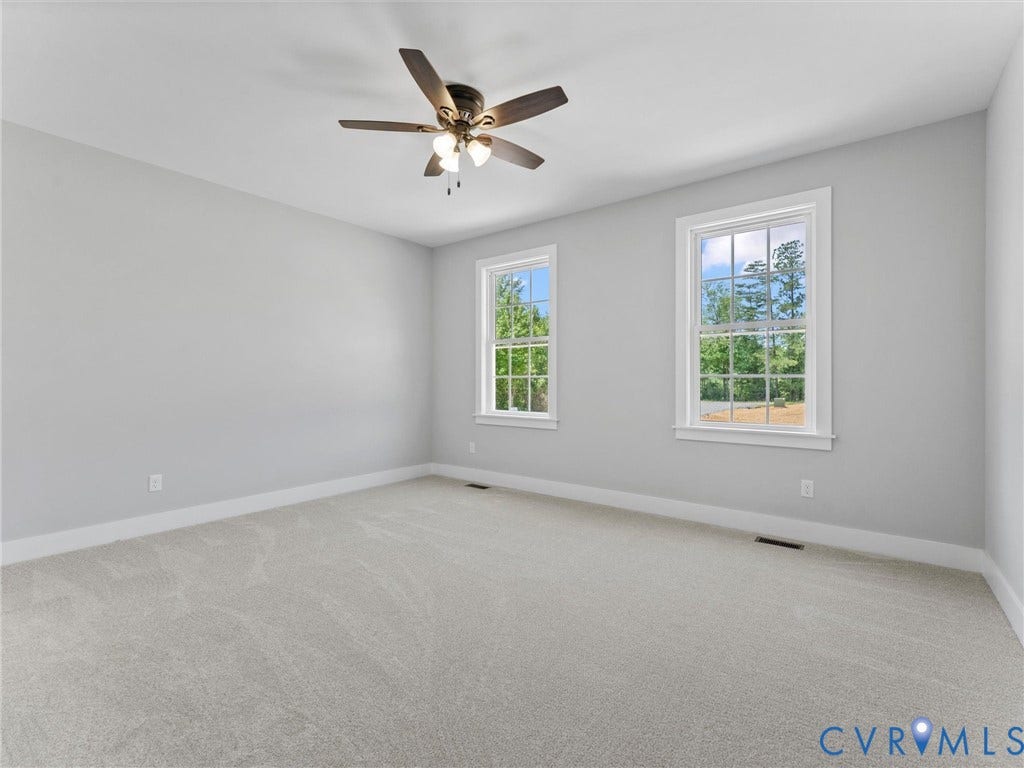 5951 Pot Rock Lane, Pot Rock Ln, Jetersville, VA 23083 Room featuring neutral-toned carpeting, two double-hung windows, and a multi-blade ceiling fan with an integrated light fixture