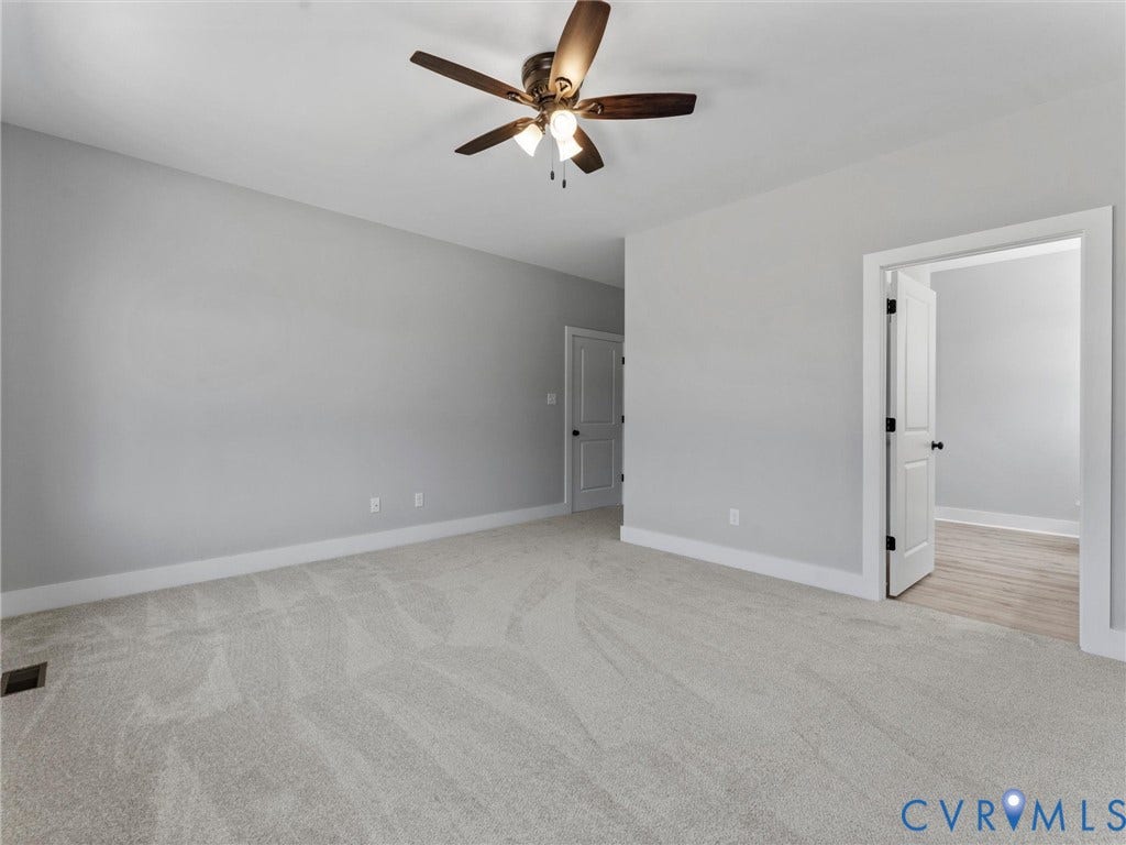 5951 Pot Rock Lane, Pot Rock Ln, Jetersville, VA 23083 Neutral-toned wall paint, plush carpeting, ceiling fan with integrated lighting, and multi-panel interior doors