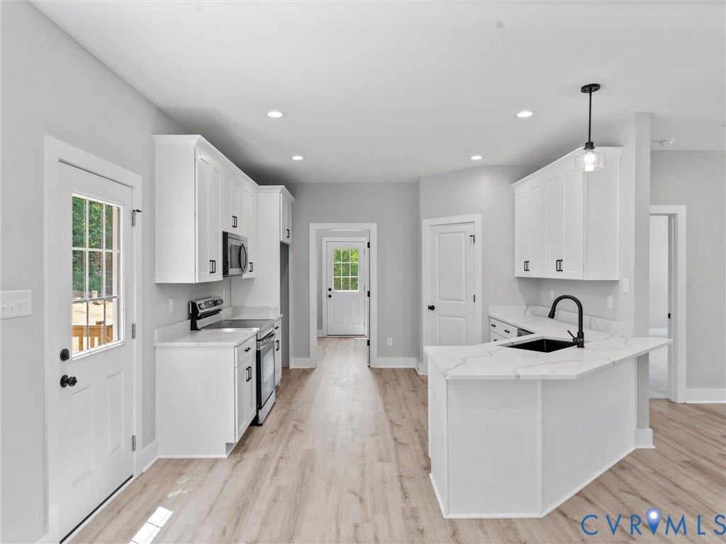 5951 Pot Rock Lane, Pot Rock Ln, Jetersville, VA 23083 Kitchen featuring white cabinetry, quartz countertops, a peninsula with an undermount sink, matte black fixtures, and wood-finish flooring