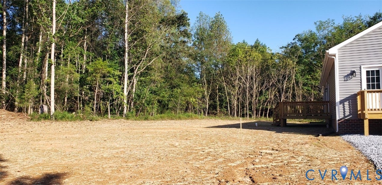 5951 Pot Rock Lane, Pot Rock Ln, Jetersville, VA 23083 Expansive backyard featuring cleared level terrain, a wood deck, and mature woodland borders