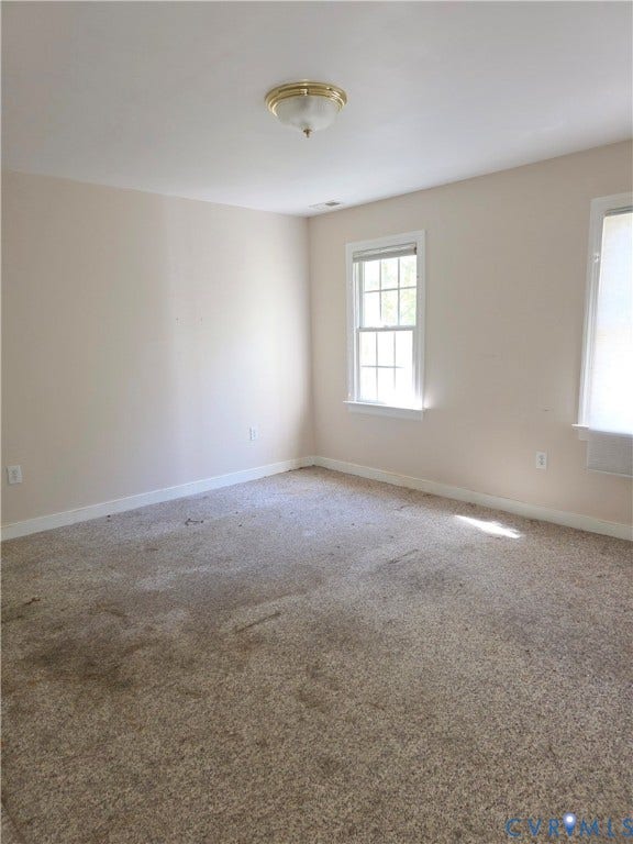 3350 North Road, Sandy Hook, VA 23153 Neutral-toned walls, wall-to-wall carpeting, multiple double-hung windows, and a flush-mount ceiling light fixture