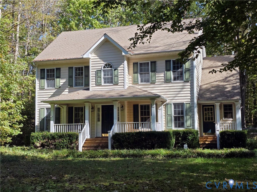3350 North Road, Sandy Hook, VA 23153 Two-story colonial residence featuring horizontal siding, a covered front porch with white railings, and decorative window shutters