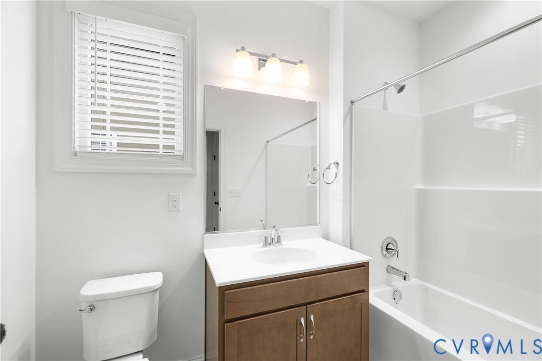 652 Overby Bend Road, Highland Grove, Richmond, VA 23222 Bathroom with a wood-finish vanity, white countertop, and integrated sink