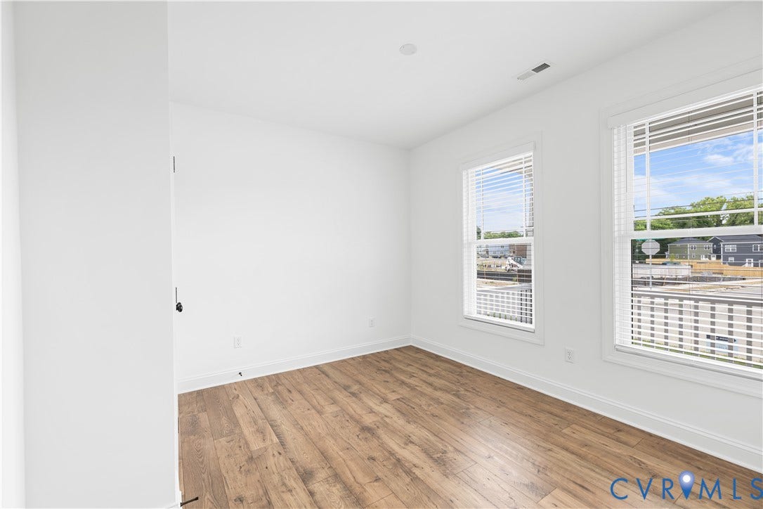 652 Overby Bend Road, Highland Grove, Richmond, VA 23222 Bright room featuring wood-finish flooring, white walls, and two windows with blinds