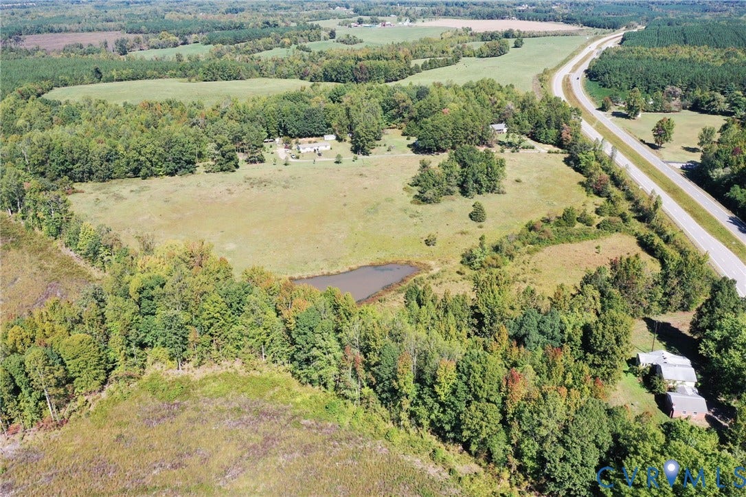 00 Patrick Henry HWY, Detached, Burkeville, VA 23922 Aerial view of expansive acreage featuring open pasture, mature woodland, and a private pond