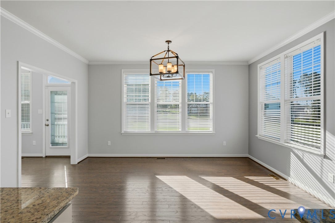 11936 Helmway Court, Chester, VA 23839 Open-concept room featuring wood-finish flooring, crown molding, a multi-light geometric chandelier, and large windows with horizontal blinds