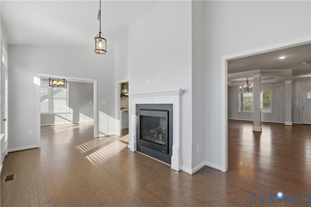 11936 Helmway Court, Chester, VA 23839 Vaulted ceilings, wood-finish flooring, and a fireplace featuring a detailed white mantel
