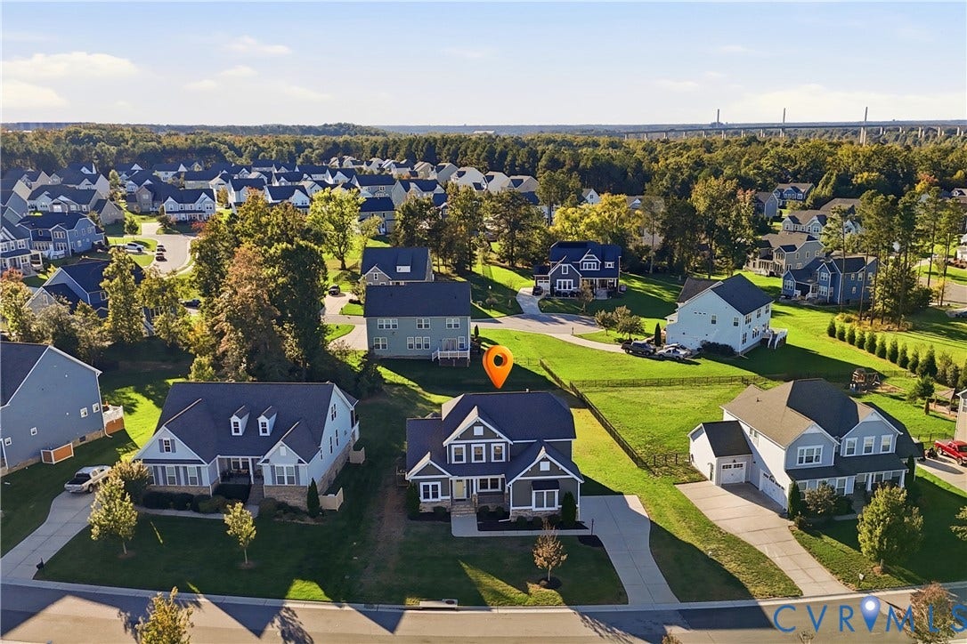 11936 Helmway Court, Chester, VA 23839 Aerial perspective of a detached residential property featuring a multi-gable roofline, a paved driveway, and a fenced rear yard