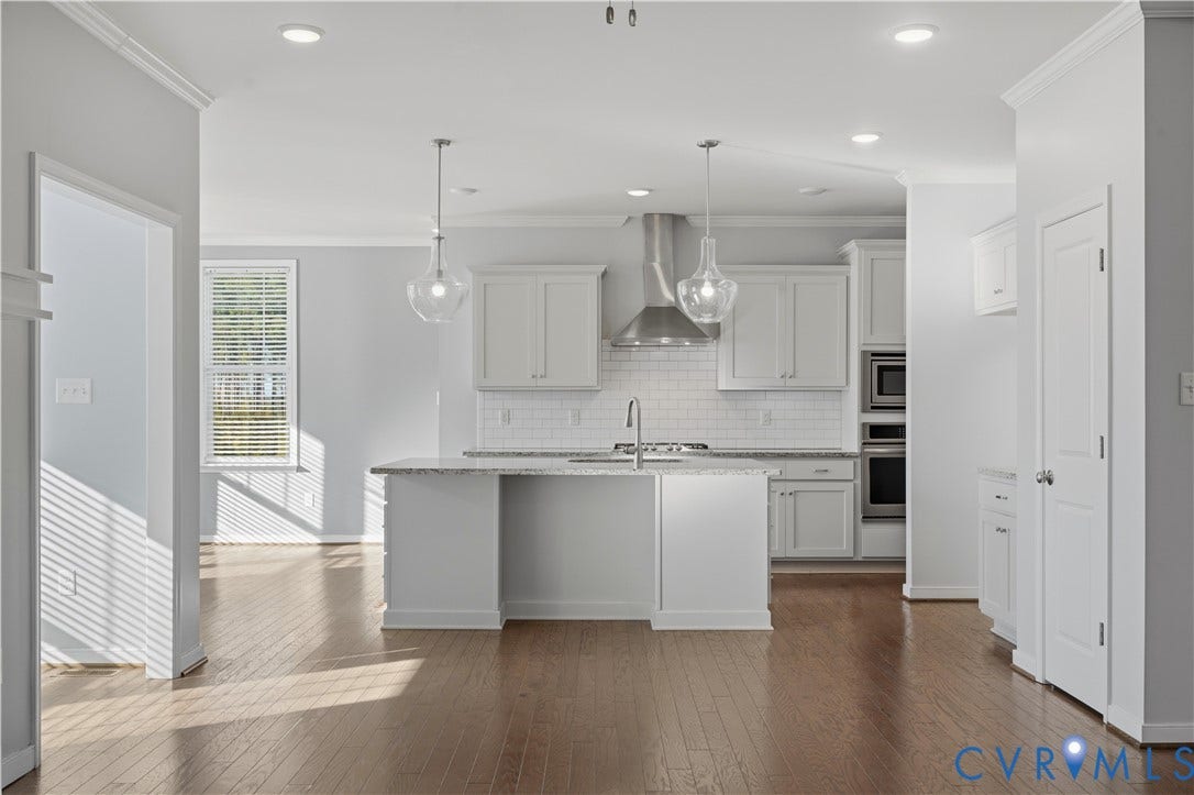 11936 Helmway Court, Chester, VA 23839 Kitchen featuring an island with a stone countertop, white shaker-style cabinetry, a stainless steel range hood, subway tile backsplash, and wood-finish flooring