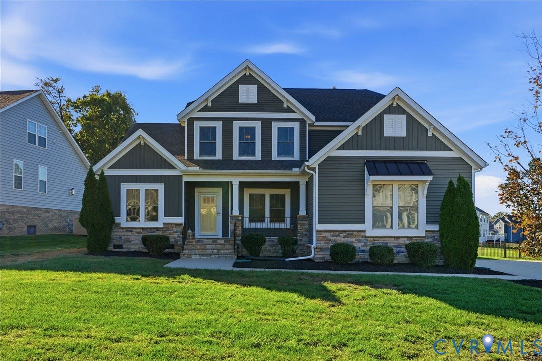11936 Helmway Court, Chester, VA 23839 Two-story exterior featuring multi-textured horizontal and vertical siding, stone veneer base, metal window awning, and gabled rooflines