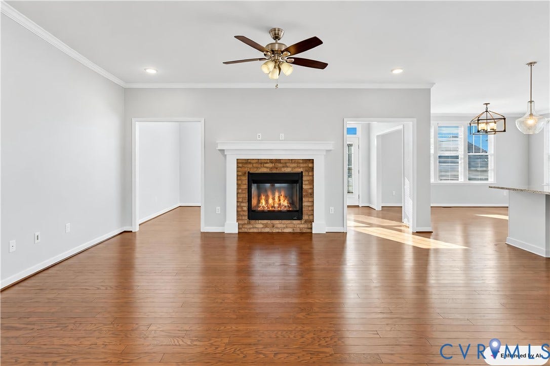 11936 Helmway Court, Chester, VA 23839 Open-concept interior featuring wood-finish flooring, brick fireplace with a white mantel, crown molding, ceiling fan, and recessed lighting