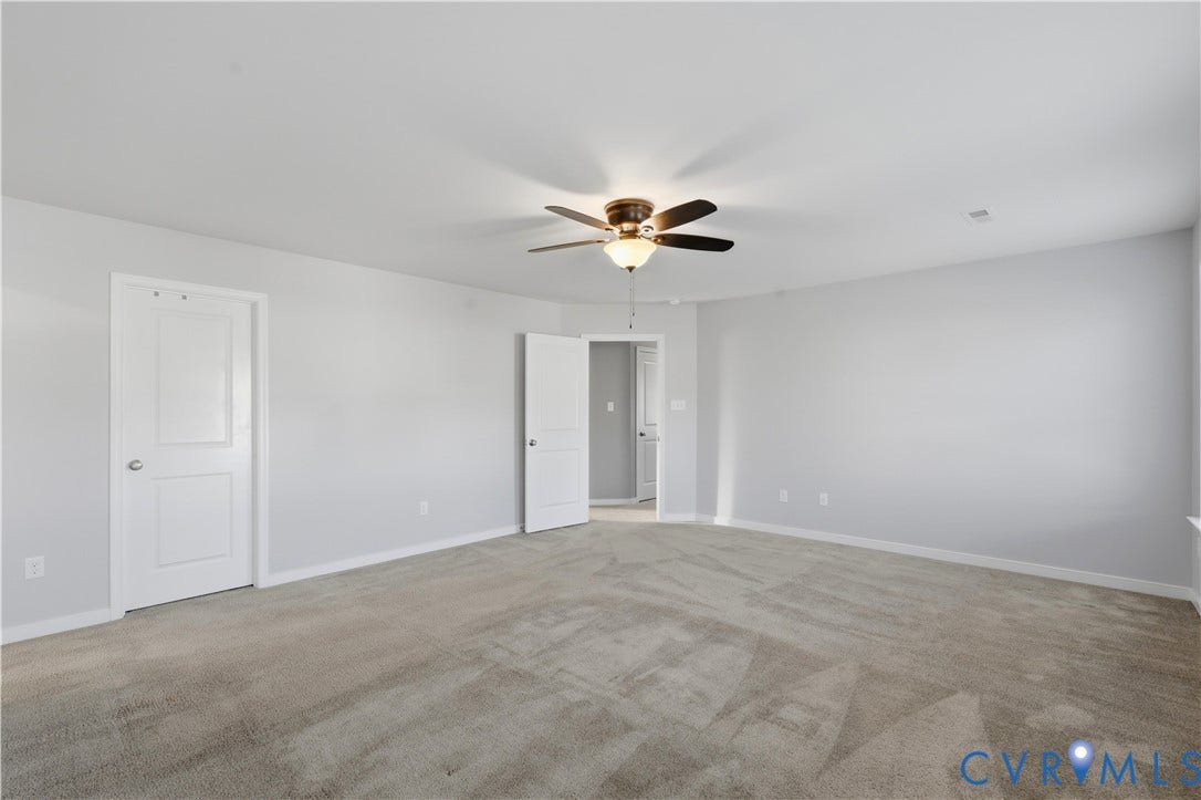 11936 Helmway Court, Chester, VA 23839 Upstairs Primary Bedroom or bedroom #2. Neutral interior room featuring neutral wall-to-wall carpeting, a central ceiling fan with integrated lighting, and white multi-panel interior doors