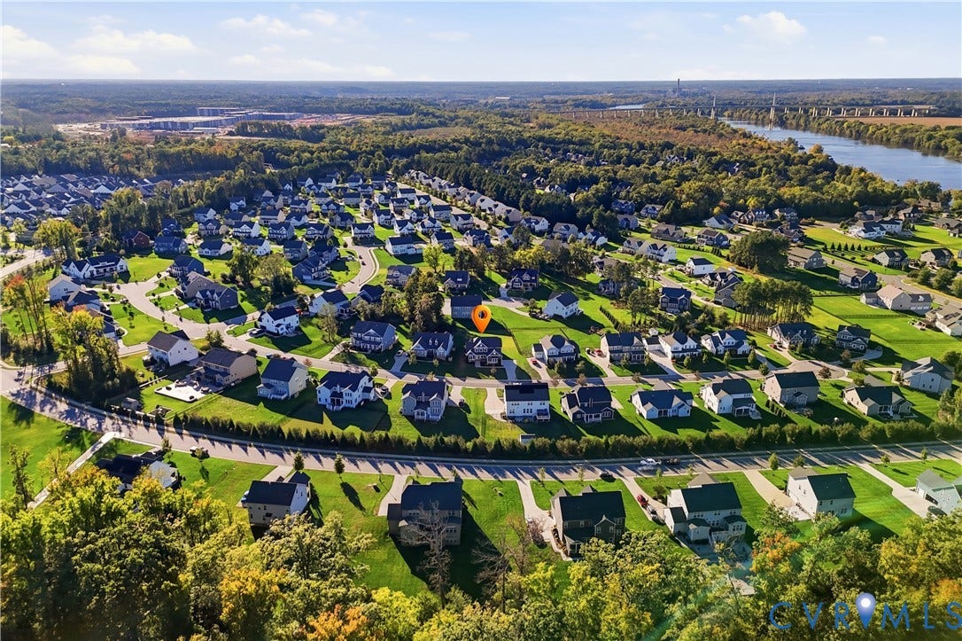 11936 Helmway Court, Chester, VA 23839 Aerial perspective featuring a residential community with paved streets, landscaped green spaces, and mature tree clusters