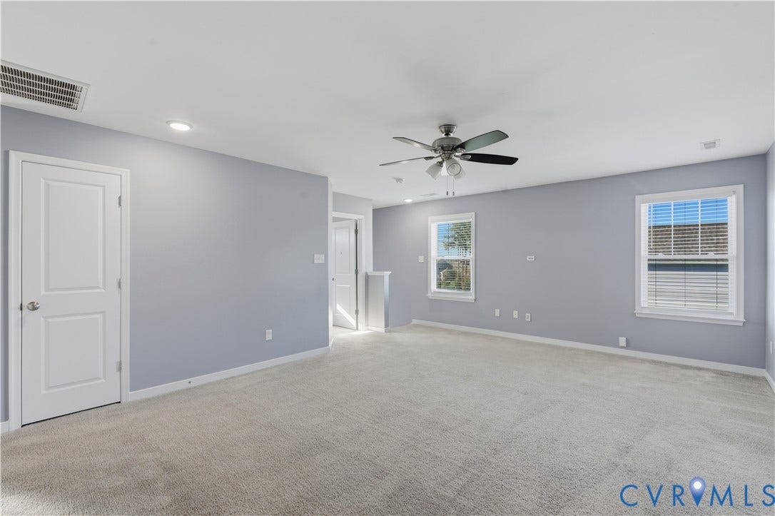 11936 Helmway Court, Chester, VA 23839 Neutral-toned interior space featuring neutral wall-to-wall carpeting, recessed ceiling lighting, a multi-blade ceiling fan with integrated light fixture, and windows with white casings