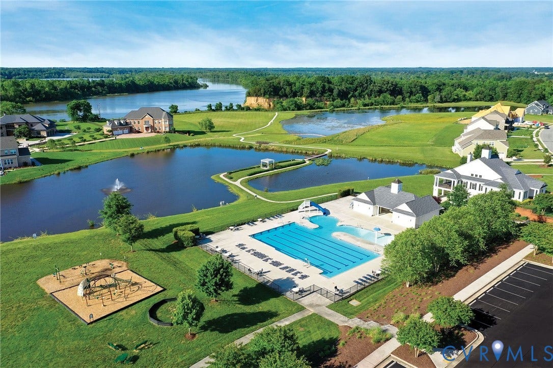 11936 Helmway Court, Chester, VA 23839 Community swimming pool with lap lanes and a slide, dedicated playground area, expansive landscaped grounds, central water feature with fountain, paved parking and clubhouse.