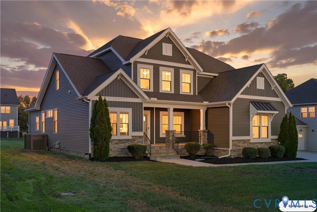 11936 Helmway Court, Chester, VA 23839 Two-story traditional exterior featuring horizontal siding, stone veneer foundation, multi-gabled roofline, covered front porch with stone-clad columns, and a metal-roofed accent awning