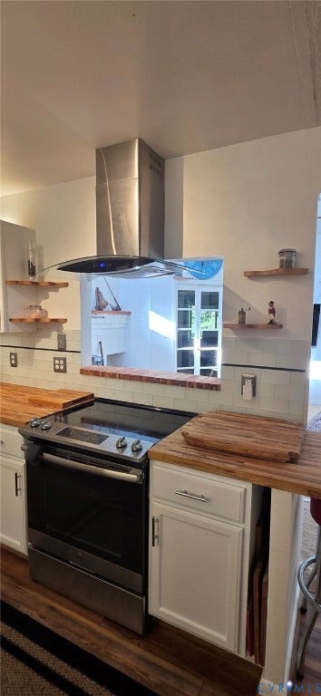 2106 Turtle Run Drive, #11, Henrico, VA 23233 Kitchen featuring stainless steel range, professional-style stainless steel chimney hood, wood-finish countertops, subway tile backsplash, and built-in floating shelves