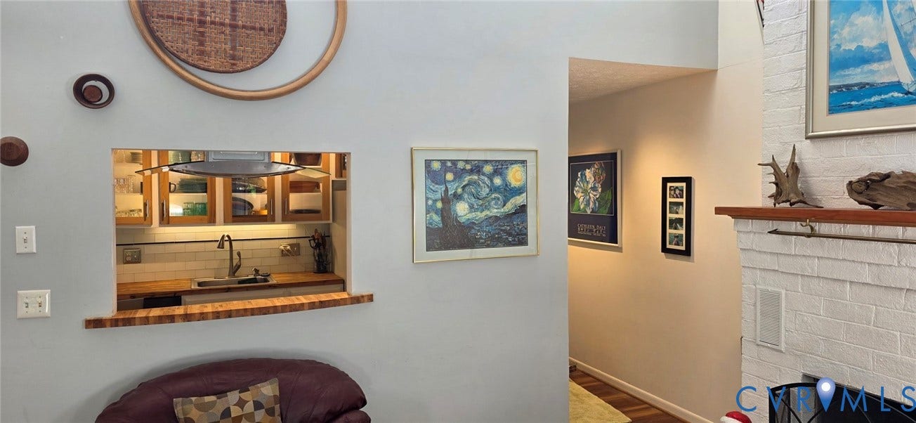 2106 Turtle Run Drive, #11, Henrico, VA 23233 Interior space featuring a vaulted ceiling, painted brick fireplace with a wood mantel, and a pass-through window with a wood-finish counter